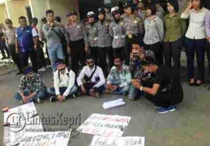 Para demonstrasi melakukan aksi tutup mulut menggunakan isolasi di PN Tanjungpinang, Selasa (2/8)